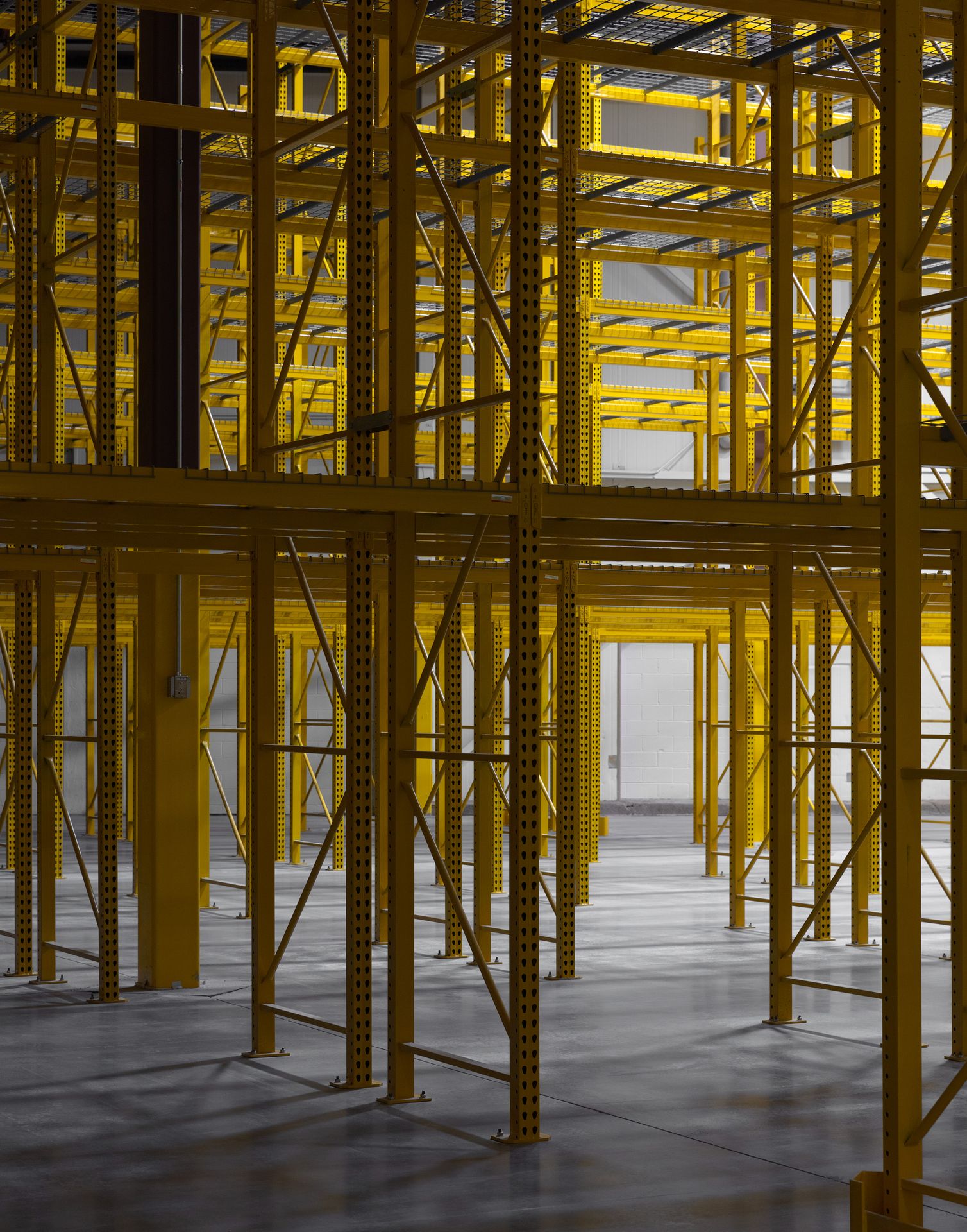 Close-up abstract perspective of tall, bright yellow industrial storage racks